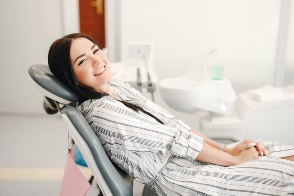 young female in dental chair waiting for her oral cancer exam