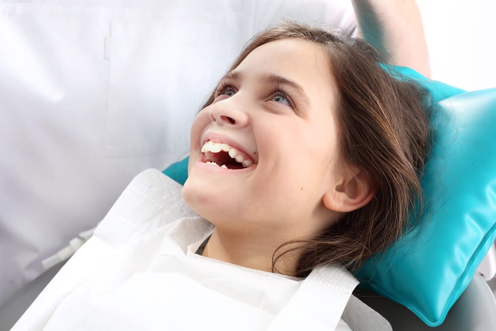 happy child at dentist with sealant work
