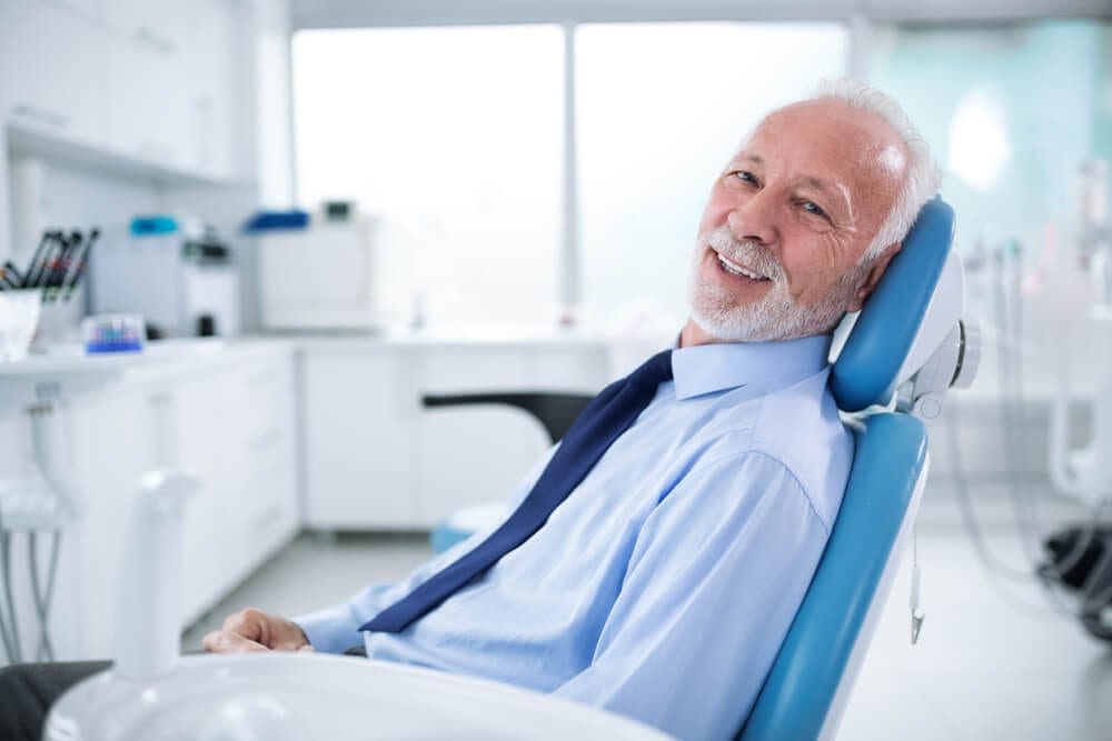older patient waiting on second opinion in dental chair